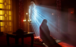muslim woman offering prayer in her room