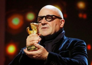 Director Gianfranco Rosi receives the Golden Bear - Best Film award for the movie 'Fuocoammare' (Fire at Sea) during the awards ceremony at the 66th Berlinale International Film Festival in Berlin, Germany, February 20, 2016.    REUTERS/Fabrizio Bensch