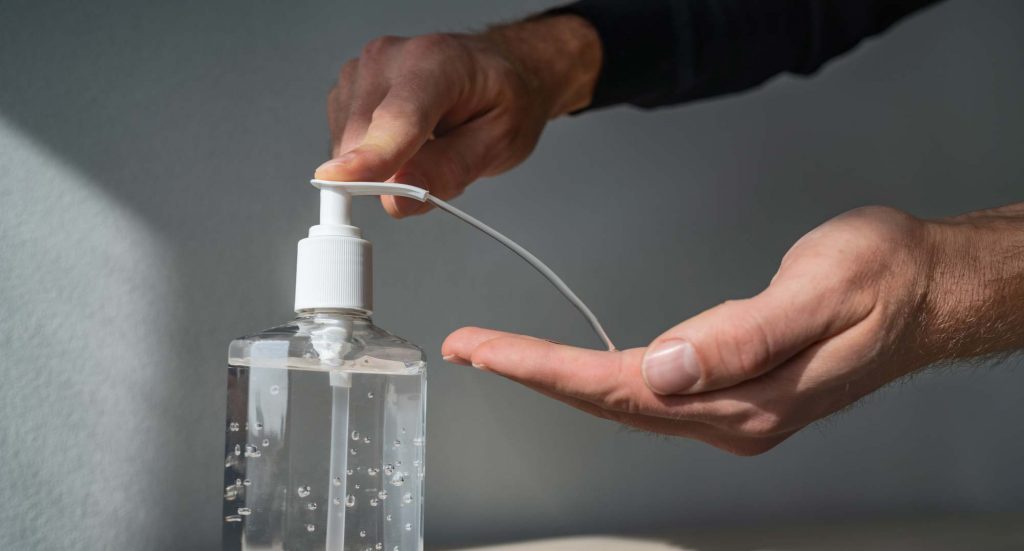 A man using Hand Sanitizer -Can Muslims Use Hand Sanitizers with Alcohol?