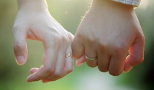 couple lovers romantic holding hands-Is Proposing to an Engaged Woman Permissible in Islam?