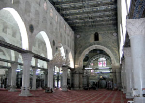 The interior of the Aqsa Mosque. The area near the mihrab (distant) dates to the Umayyad construction, while the pillars date to the Fatimid period.