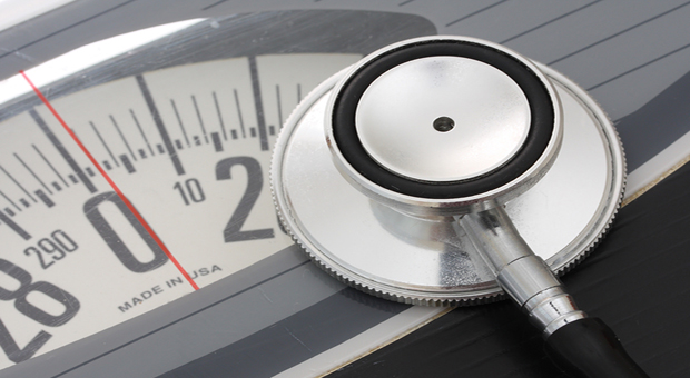 Close up of stethoscope on a weight scales