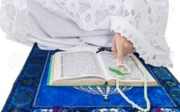 A Pregnant Woman Praying While Sitting