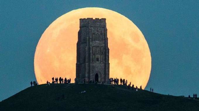 The supermoon of Sept. 27, 2015, rises behind Glastonbury Tor in Glastonbury, England. Credit: Matt Cardy/Getty Images.