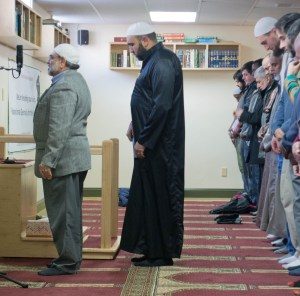 Imam Islam Hassan, in black, leads the regular Friday afternoon prayer session at the Islamic Society of Vermont in Colchester. Photo by Emily Greenberg/VTDigger