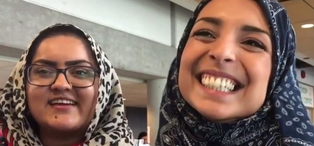 "I don't wear the hijab, but putting it on today, I felt super fierce," said Yousra Moutii, an environmental engineering student at UNBC, right, with Hira Rashid, left. (Betsy Trumpener/CBC )