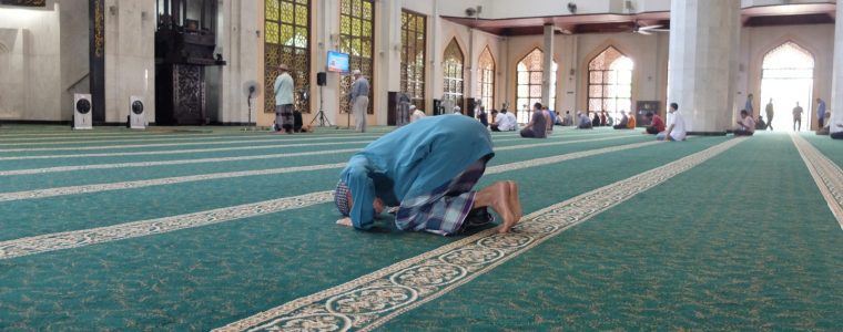 Man in prostration position in prayer