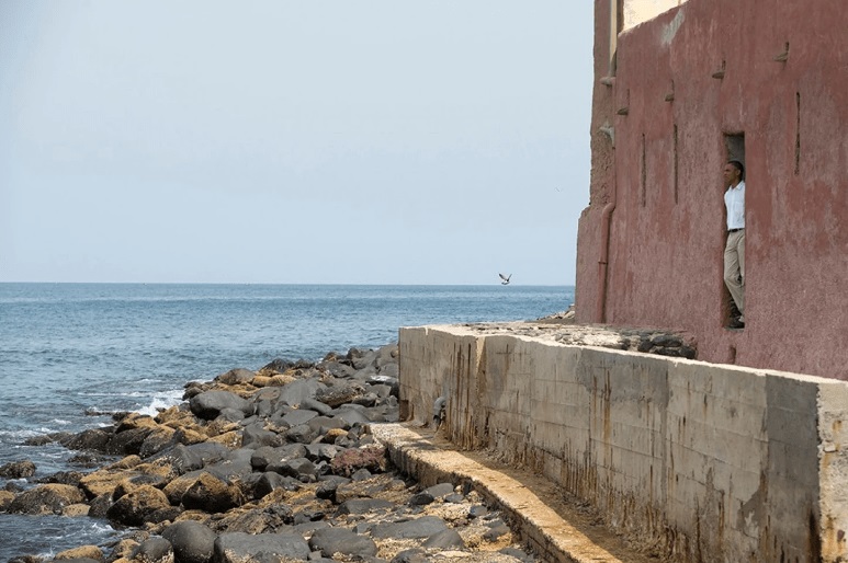 Washington Post: Former President Obama looks out of the “door of no return” during a tour of Goree Island. (AP Photo/Evan Vucci)