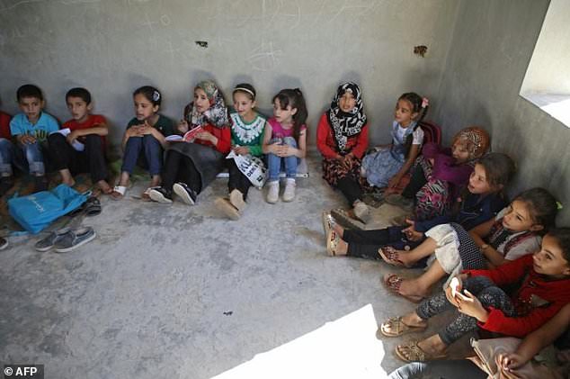 Syrian Students Sit on the Ground in Makeshift Schools