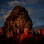 Revellers watch the sun set on the eve of the Summer Solstice at the Stonehenge stone circle, in Amesbury, Britain, June-20