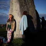 The sun rises as revellers welcome in the Summer Solstice at the Stonehenge stone circle, in Amesbury, Britain, June-21