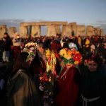 The sun rises as revellers welcome in the Summer Solstice at the Stonehenge stone circle, in Amesbury, June-21