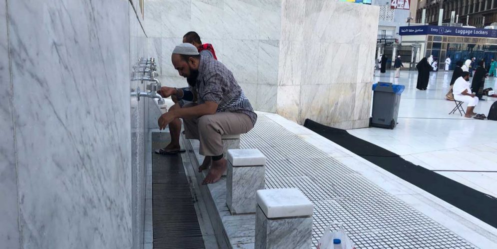 Muslim men making wudu