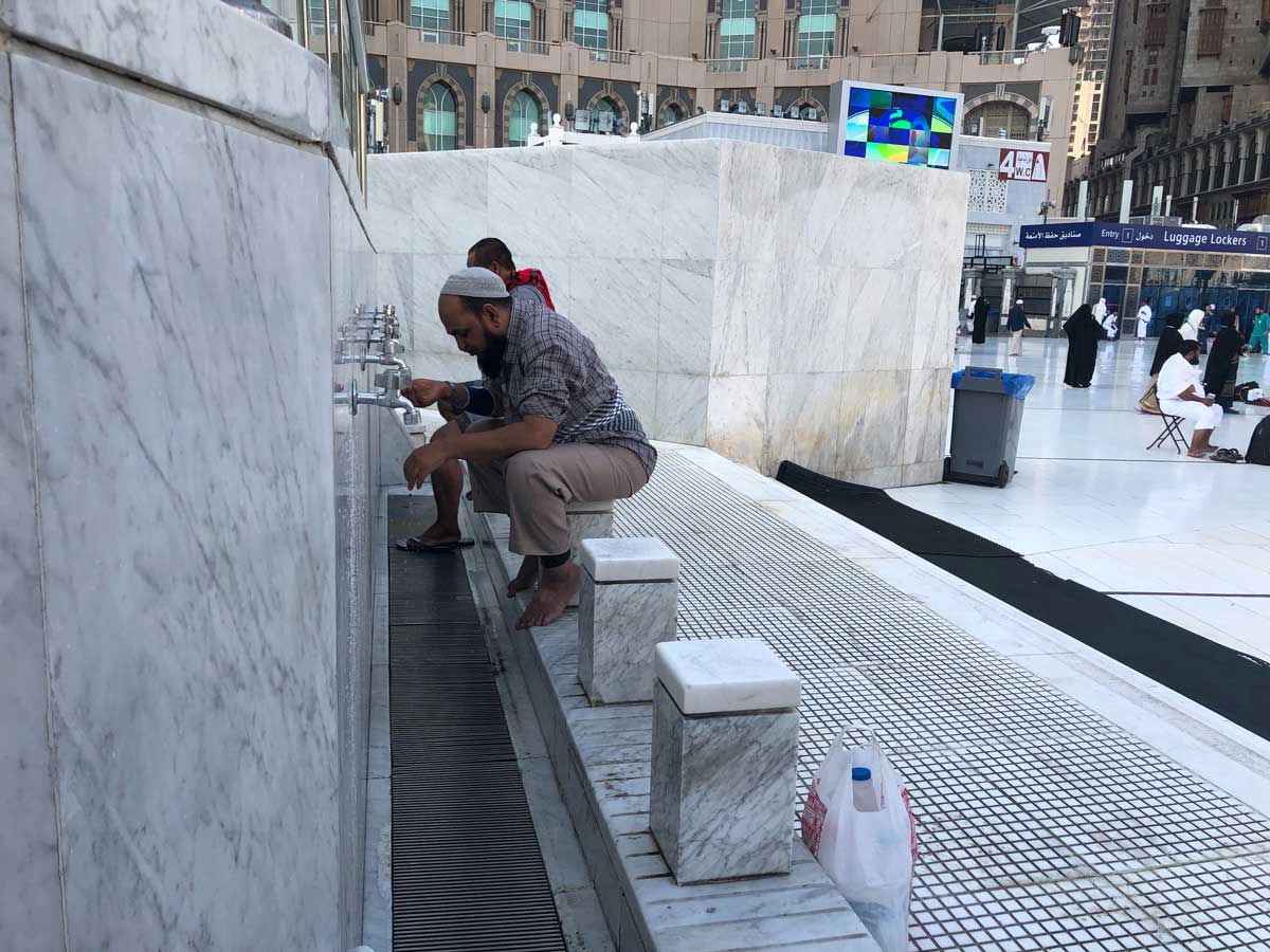 Muslim men making wudu