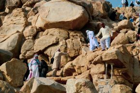 Pilgrims trying to Climb Mount Arafah