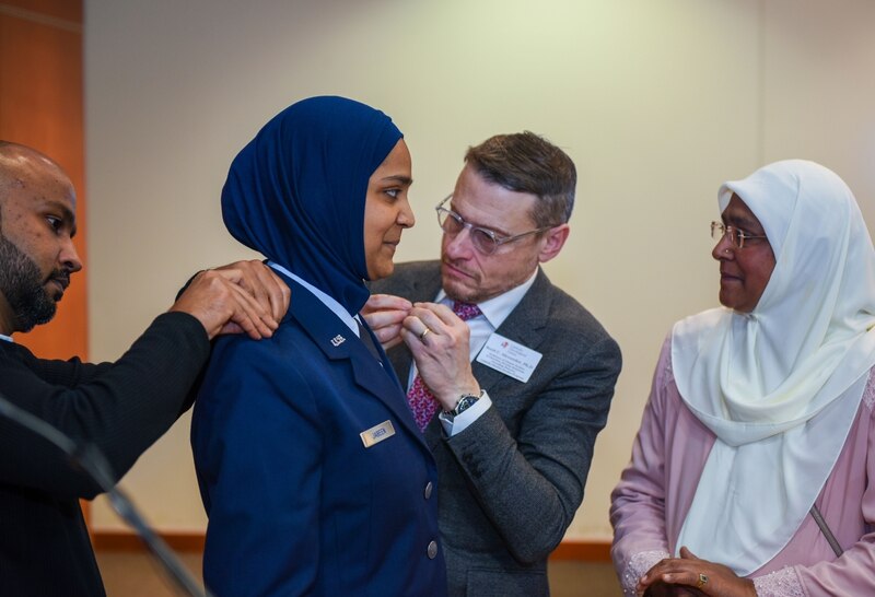 Friends and family members of chaplain candidate Saleha Jabeen pin on her second lieutenant rank, during a commissioning ceremony, Dec. 18 at the Catholic Theological Union in Chicago. Jabeen entered the U.S. Air Force as the first female Muslim chaplain candidate. (Tech. Sgt. Armando Schwier-Morales/Air Force)