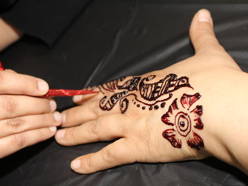 A woman gets a henna tattoo at a community open house at the Markaz Ul Islam Mosque in Fort McMurray, Alta. on Saturday, January 25, 2020. Vincent McDermott/Fort McMurray Today/Postmedia Network