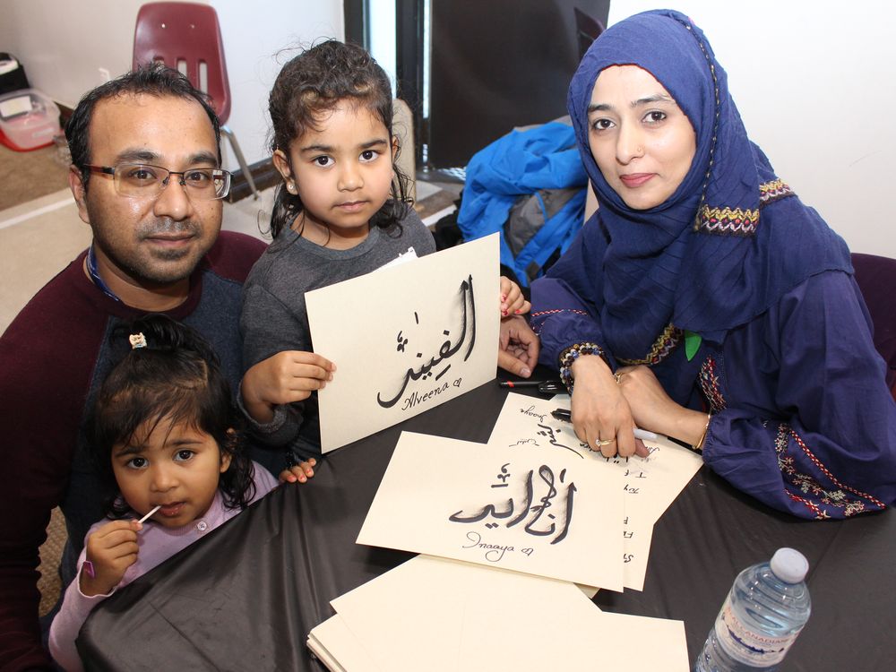 Maxim Kashem with his daughters, Inaaya and Alveena, show off their names written in Arabic calligraphy by Hira Noor at a community open house at the Markaz Ul Islam Mosque in Fort McMurray, Alta. on Saturday, January 25, 2020. Vincent McDermott/Fort McMurray Today/Postmedia Network