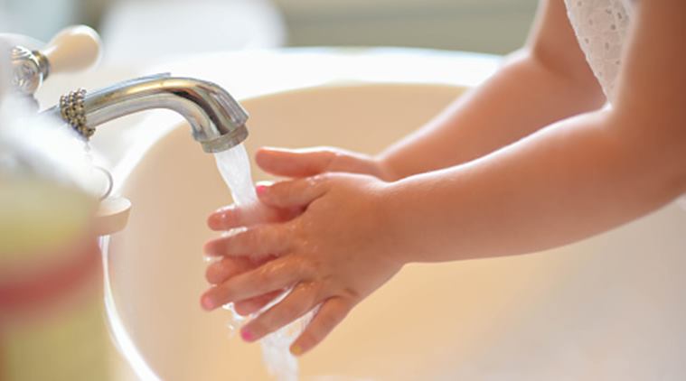 Closeup of little girl washing hands – starting healthy habits early