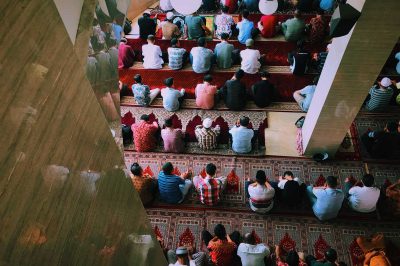 men are sitting inside the floating mosque