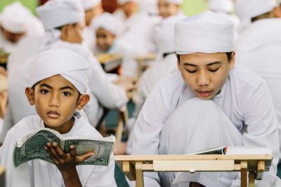 A group of Muslim children scholars known as a Tahfiz reciting Al-Quran