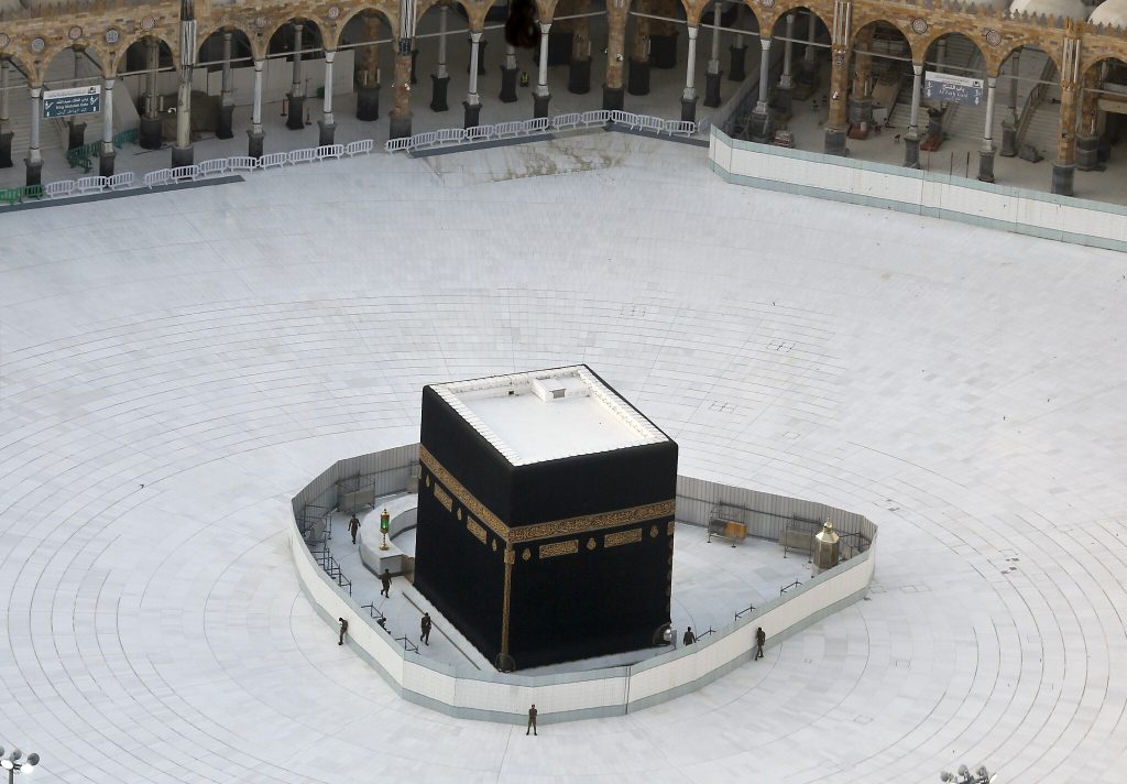 Saudi policemen guard the Kaaba, the cubic building at the Grand Mosque, in the Muslim holy city of Mecca, Saudi Arabia, Friday, March 6, 2020. Saudi Arabia emptied Islam’s holiest site for what they call sterilization of the holy place over fears of coronavirus. (AP Photo/Amr Nabil)