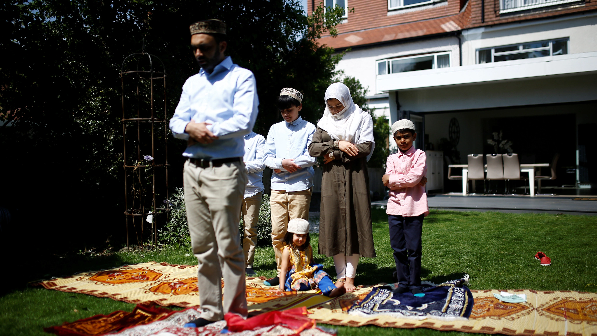 A family offer Eid al-Fitr prayers at home to mark the end of the month of Ramadan in Surbiton, London. [Image-REUTERS]