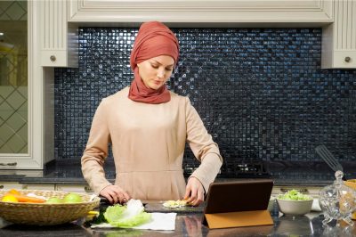 Islam woman in hijab prepares dinner