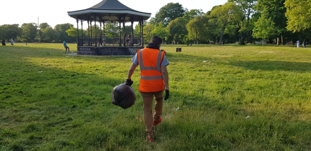 A Waste Warrior picks up picnic litter in Small Heath Park