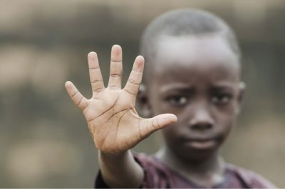 African boy says stop! Racism and war!