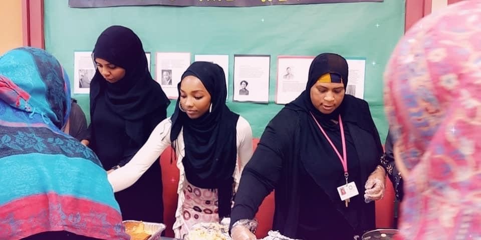 Verinique Cooper pictured to the left serving lunch at her Islamic institute before COVID-19.
