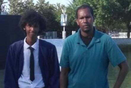Mohamed (right) standing with his son who graduated last month from high school