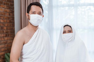 portrait of asian couple umrah. muslim hajj wearing white ihram