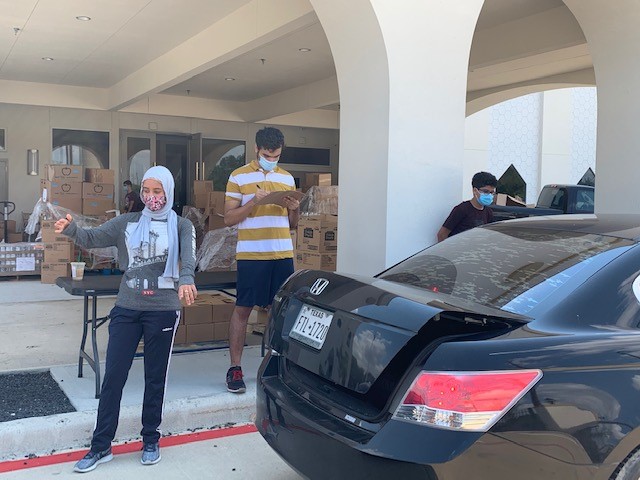 Hanan Abdelgilil (on the left) directing cars through food line