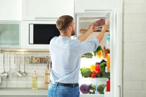 Man keeping stuff in freezer