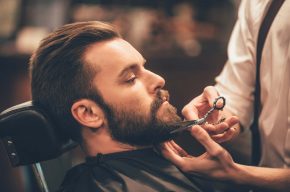 A man having his beard trimmed