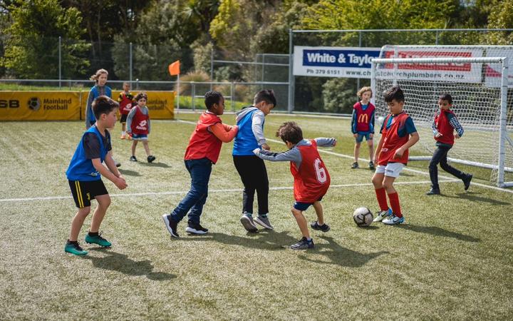 Children kicking a ball around during the New Zealand Police v Community football match. Photo: Supplied / Canterbury Resilience Foundation