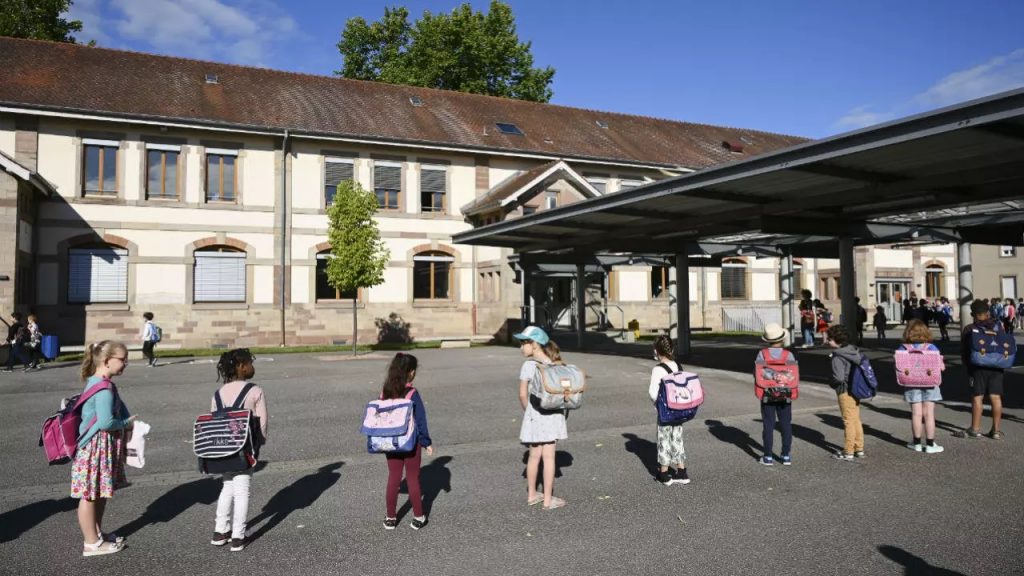 Children wait to enter their classrooms in Strasbourg on June 22, 2020, as schools reopen in France. © Frederick Floren