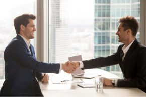 Bank employee shaking hands with a customer-Can a Muslim Work For a Bank?