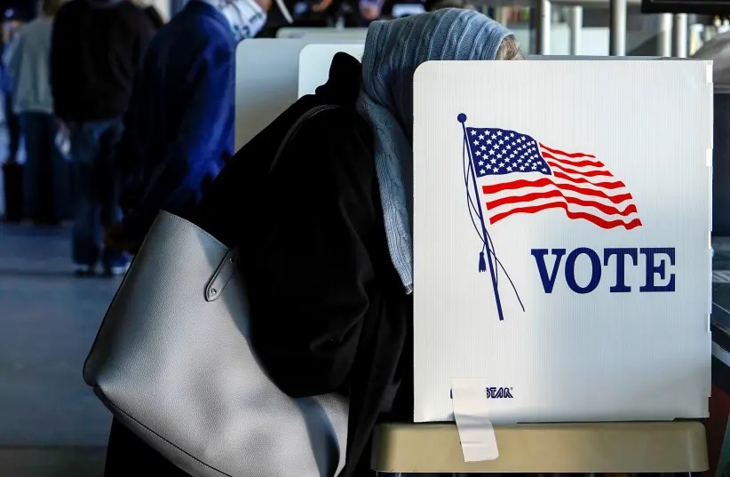 A voter fills out her ballot during early voting at ONEOK Field in Tulsa, Oklahoma, US, October 30, 2020.
(photo credit: REUTERS/NICK OXFORD/FILE PHOTO)