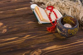 Beautiful Candle Holder With Quran And Prayer Beads On Desk Photo Background-Can I Listen to the Quran for Pleasure?