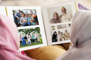 Muslim family looking in a photo album-What to Do with Pre-Hijab Photos?