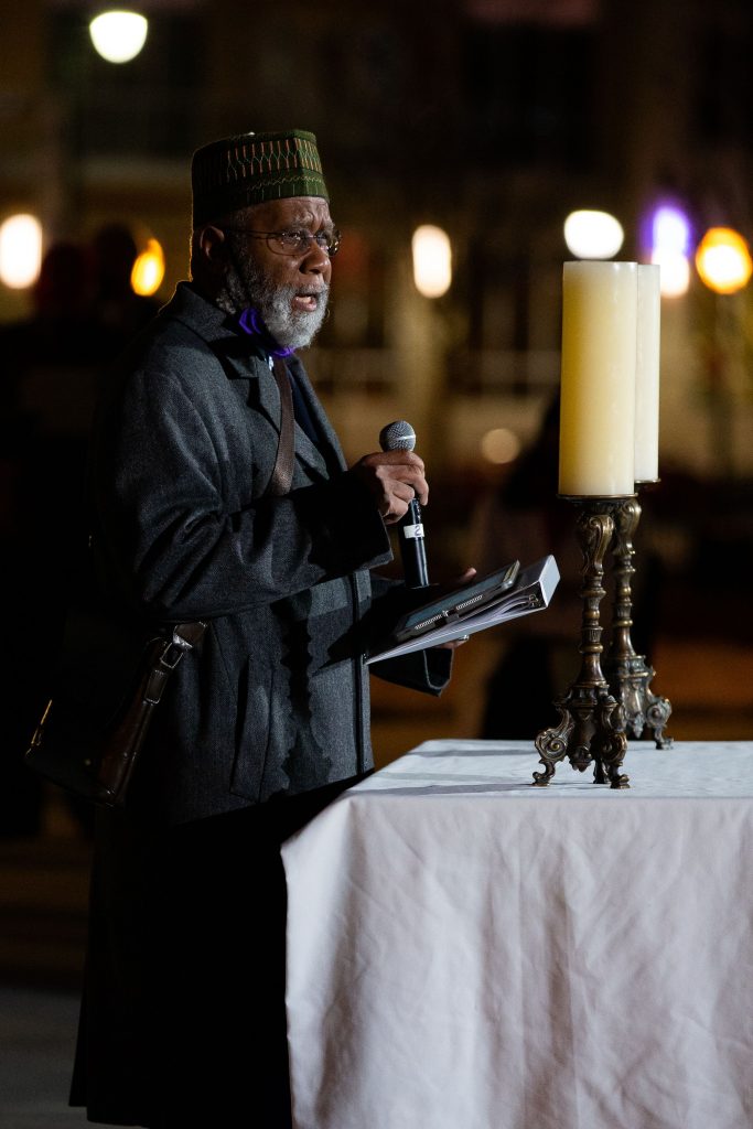 Bilal Mahmud, founder and board member of Al-Farooq Masjid, speaks during the vigil on Sunday