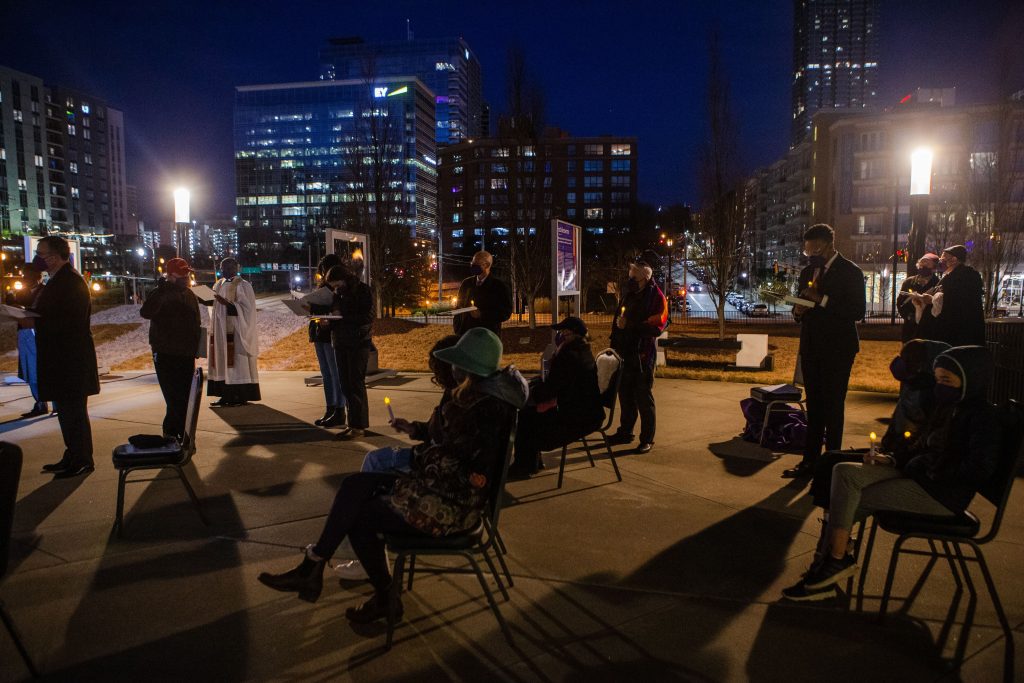 Attendees listen to speakers during the vigil on Sunday, January 3, 2021, outside the National Center for Civil and Human Rights in Atlanta.