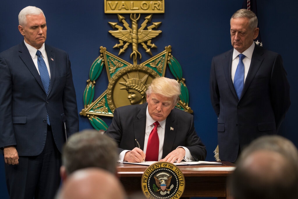 Trump signing the executive order in 2017.Credit…Stephen Crowley/The New York Times