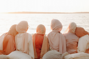 back view of six women wearing hijab sitting on beach-Is Hijab Cultural or Religious in Islam?