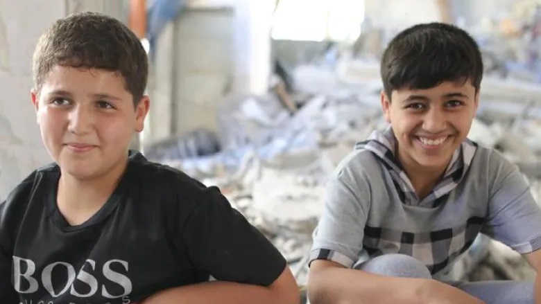 Two Palestinian youth receive aid package from the Windsor Islamic Association. (Submitted by Osama Warsi/IDRF)