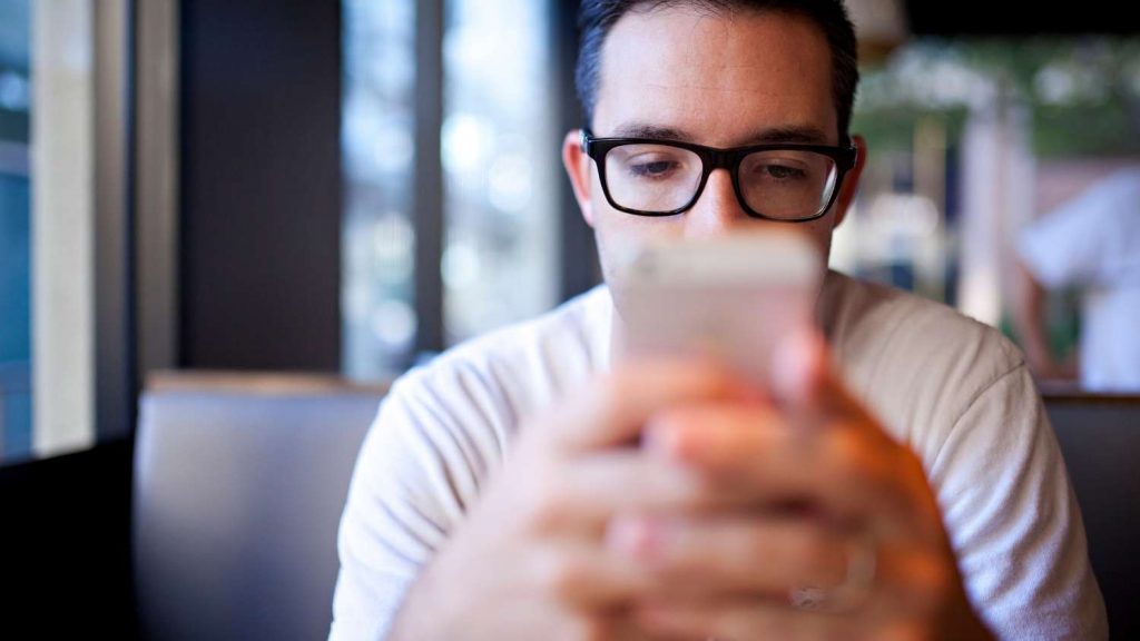 A Man Watching something on his mobile