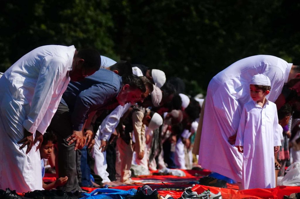 People during morning prayer during Eid al-Adha, or festival of sacrifice, in Southall Park, Uxbridge, UKPhotograph: Victoria Jones/PA