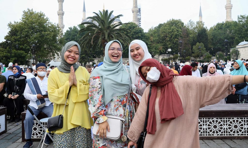  Muslims pose for photo at Sultanahmet Square after performing Eid al-Adha prayer at Hagia Sophia Grand Mosque in Istanbul, Turkey Photograph: Anadolu Agency/Getty Images